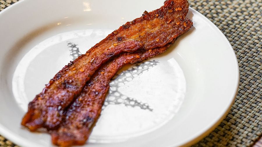 Crispy, perfectly cooked bacon served alongside a fresh cup of coffee - Brewery Gulch Inn & Spa