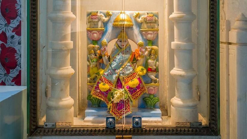 image of an idol placed inside  glass chamber
