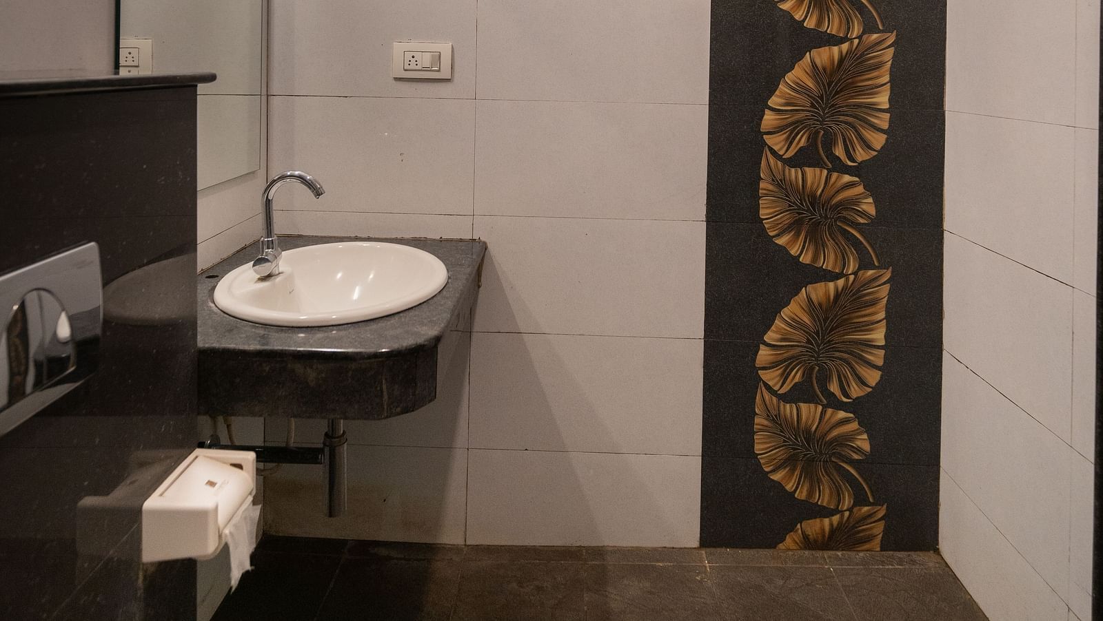 Image of a washroom with a sink and toilet at Parampara Resort & Spa, Kushalnagar.