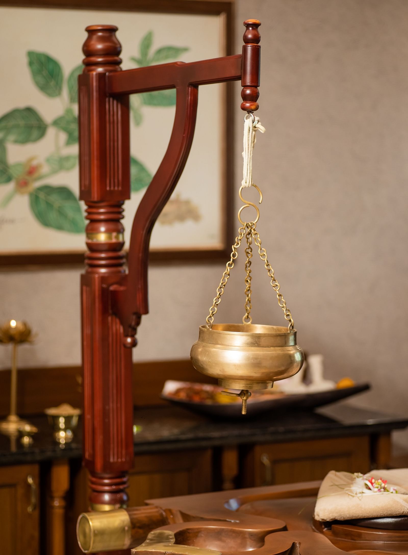 A close up shot of a device to keep a brass bowl used for shirodhra - Gamyam Resort