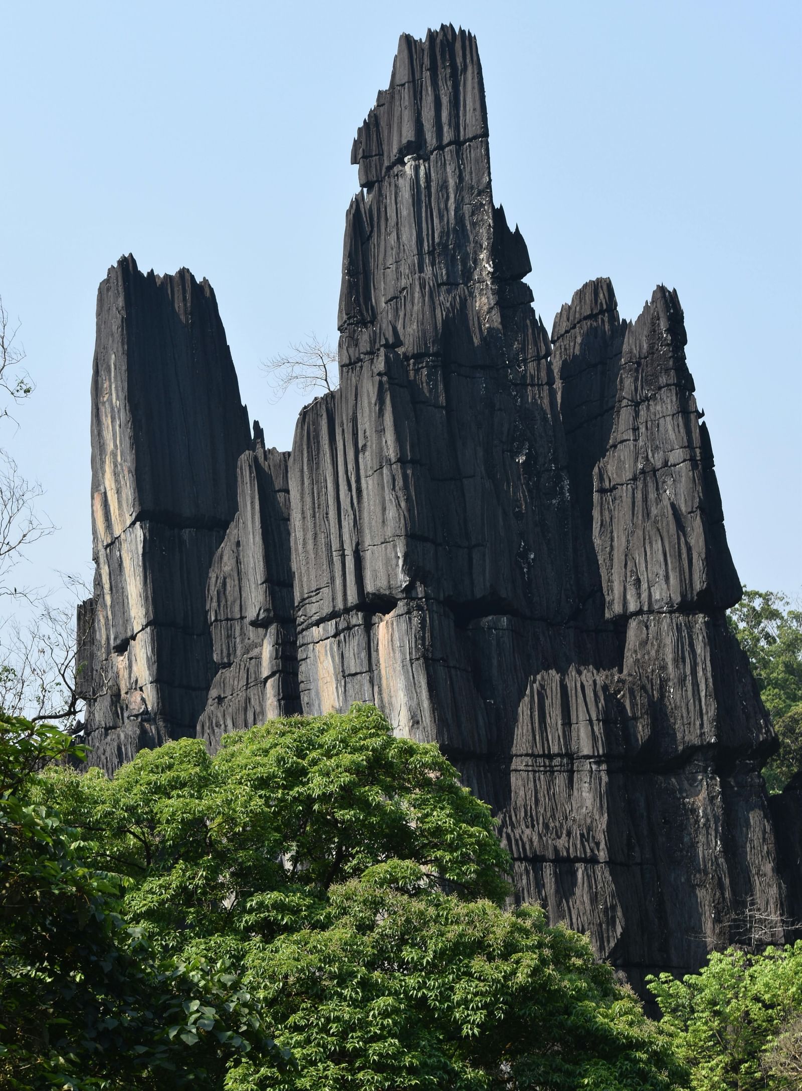 Jagged limestone peaks soaring high above the lush greenery, showcasing the distinctive landscape of Yana Caves.