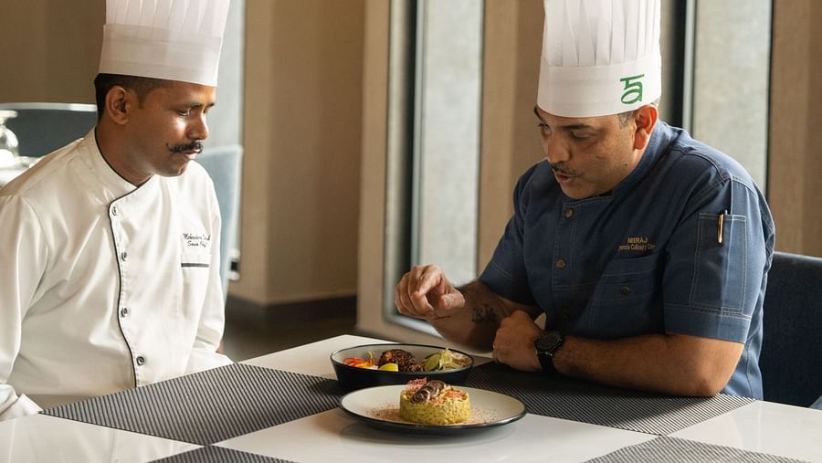Two chefs trying out a dish at Ananta Spa and Resort, Ajabgarh