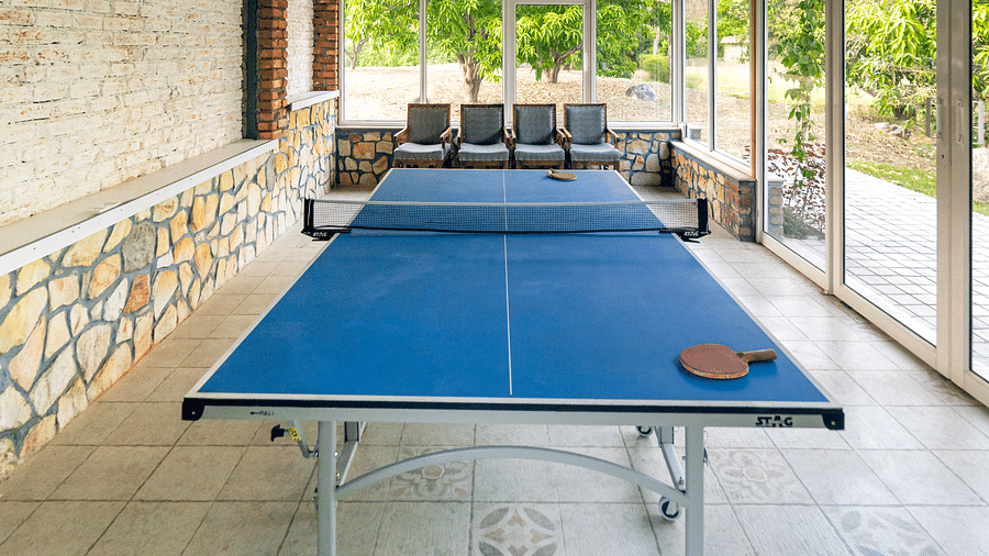 A table tennis table situated in an open room at the Sylvan Retreat, Dehradun.