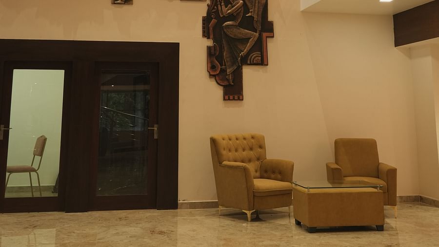 An image of of seating area with sofa set and decorative art pieces hanged on the wall - Mastiff Grand, Dharwad