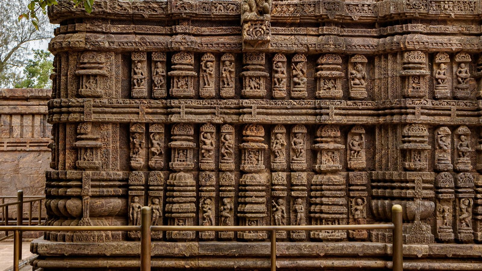 Facade image of a temple's wall with intricate carvings on it