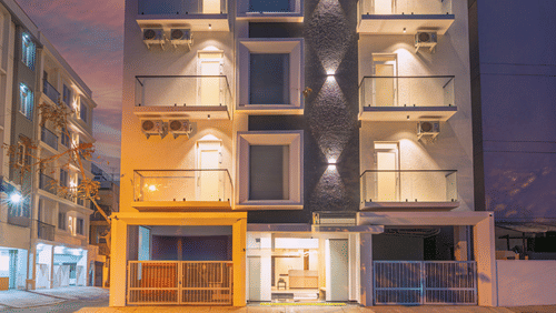 Modern hotel facade illuminated at night with contemporary architecture at Rivido - Manyata.