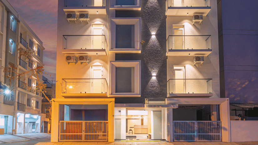 Modern hotel facade illuminated at night with contemporary architecture at Rivido - Manyata.