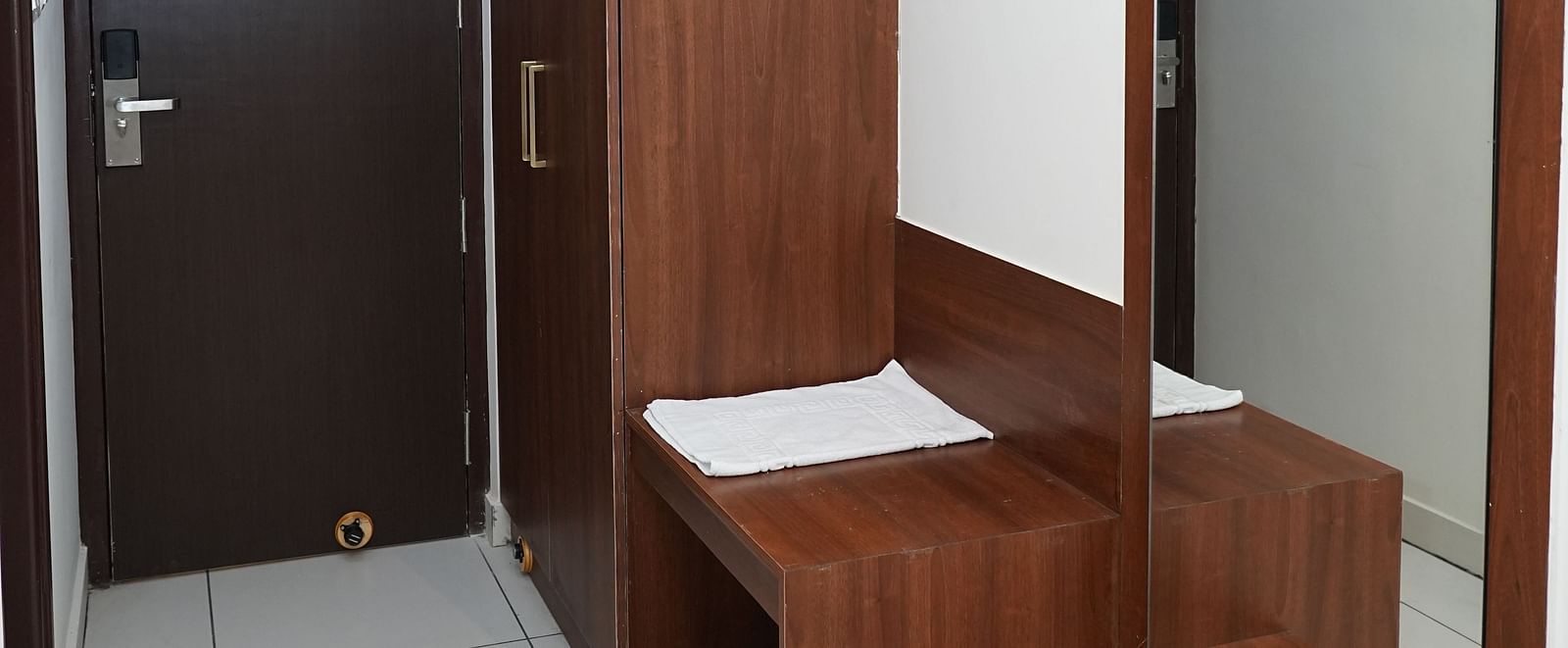 side view of the dressing table with a wide full length mirror along with a wooden wardrobe - Hotel Grand Sigma