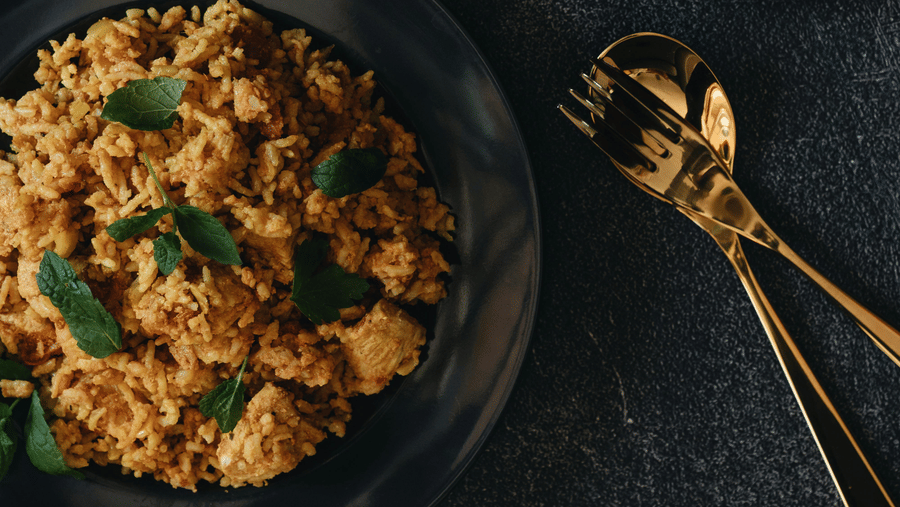 2 bowls of spiced Chettinad-style dry curry placed on a dark surface, showcasing coarse texture, herbs, and traditional South Indian preparation