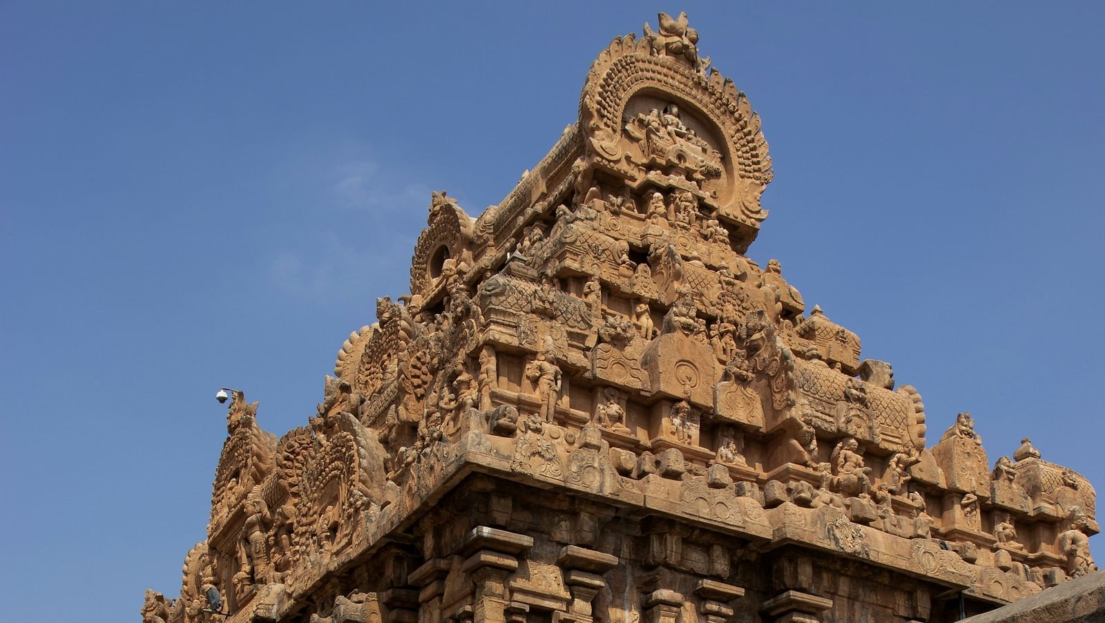 Ancient stone temple with intricate carvings and weathered architecture.