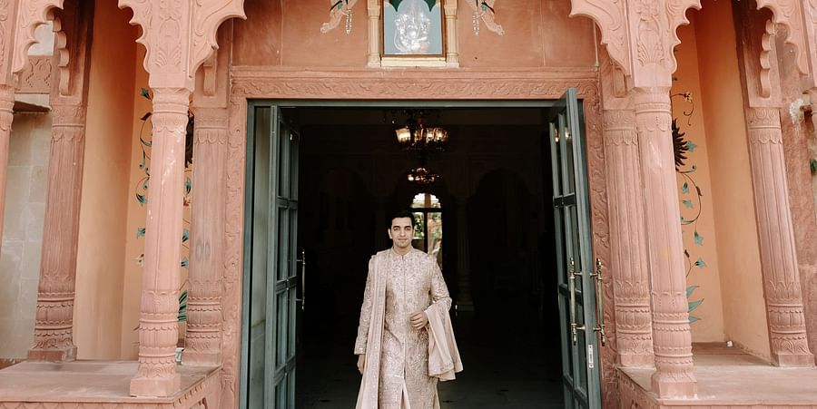 Traditional architecture view with groom entering the venue.