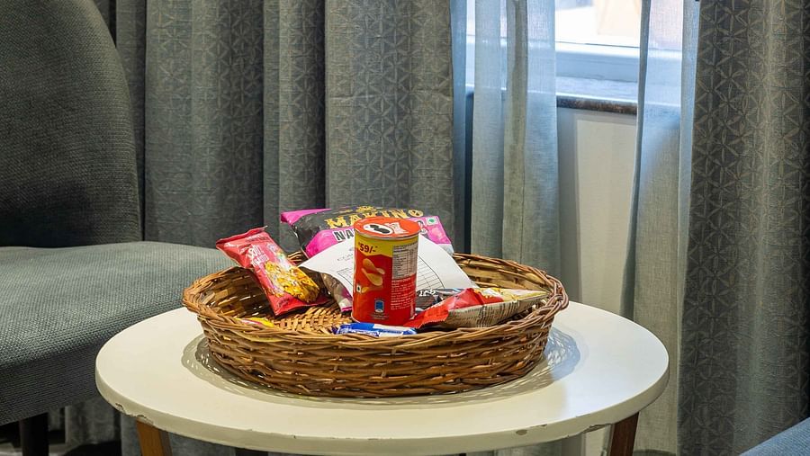 Image of varieties of snacks placed on a small bamboo basket on the coffee table at Coral Reef Hotel and Spa in Port Blair