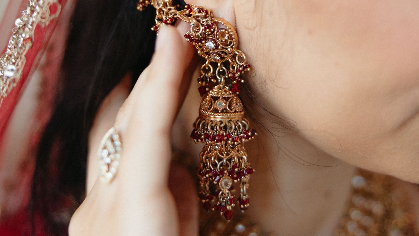 A close up shot of a  woman wearing a earring