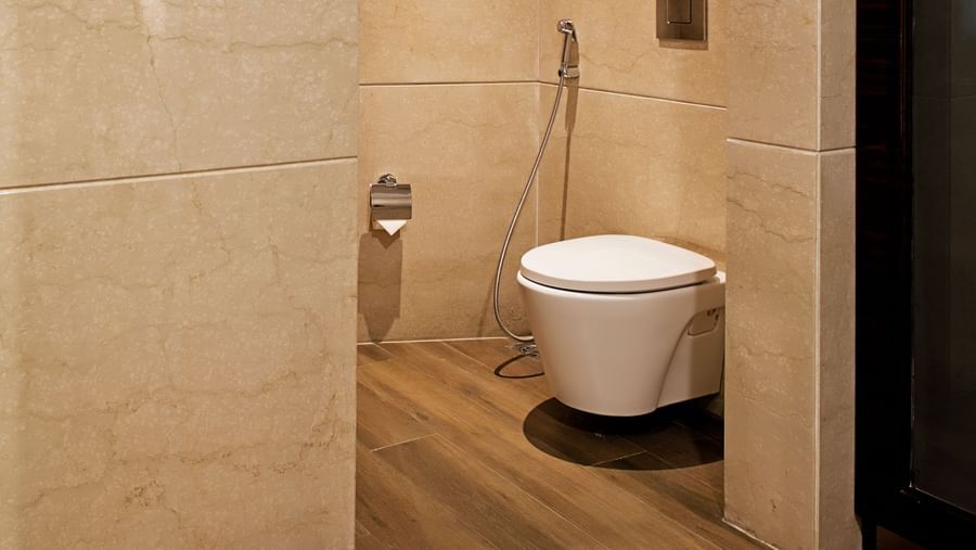 A bathroom at Barsana Boutique Hotel, Kolkata, with a toilet and shower space.