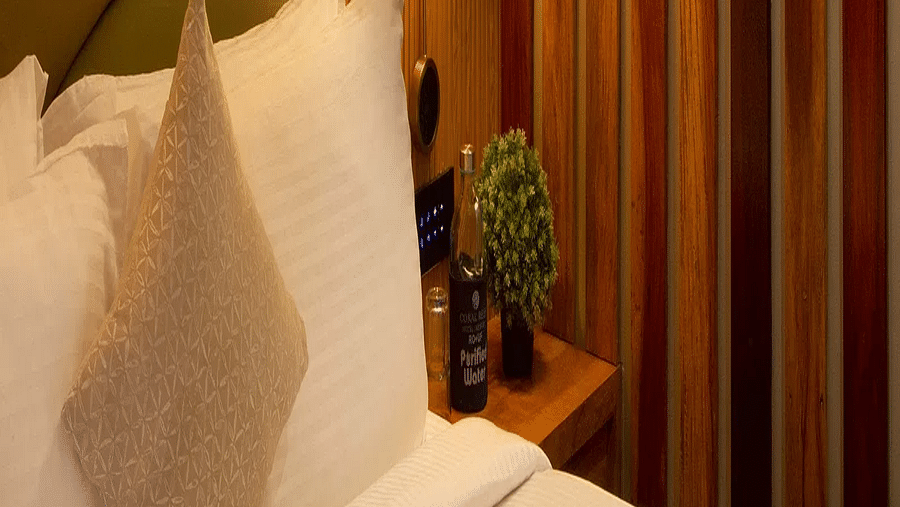 Image of Coral Sapphire at Coral Reef Resort and Spa in Havelock featuring a plush bed under warm lighting and a wall painting next to it on the wall