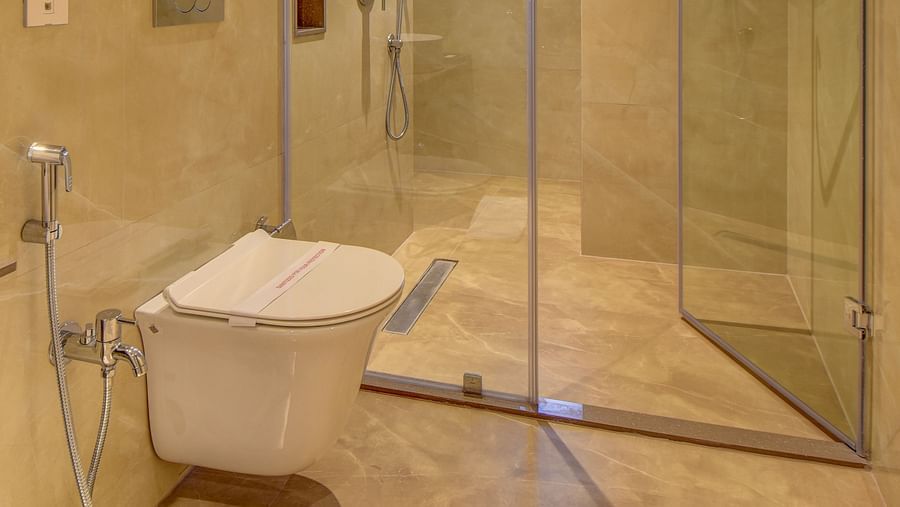 Washroom of a room at The SSK Solitaire Boutique Hotel & Spa, Gangapur Road - Nashik featuring a sink area and a mirror with warm lighting.