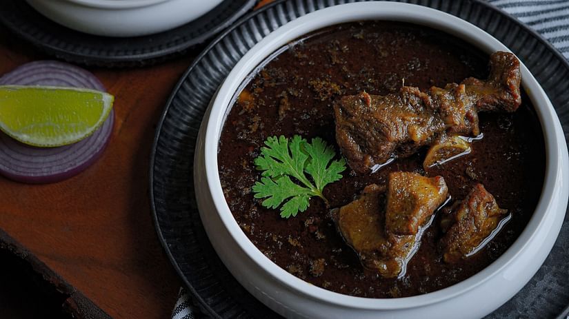 a table filled with dishes of mutton and rice