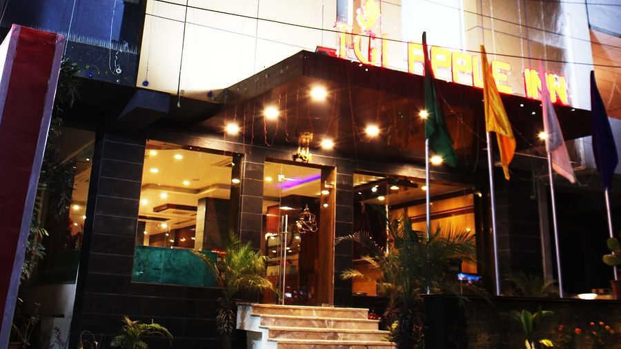 A low angle shot of the hotel at night illuminated by yellow and white lights showcasing the grandeur of the hotel - TGI Apple Inn, Jaipur 