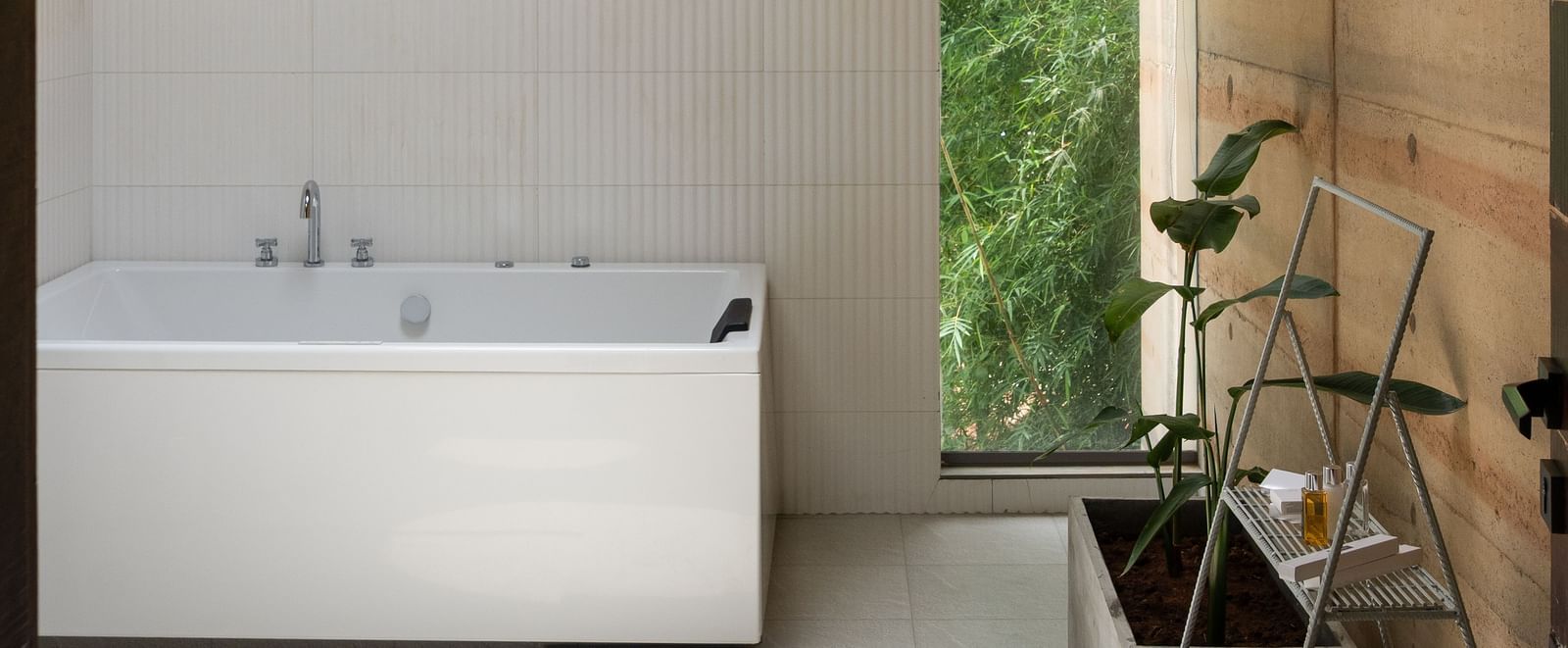 A modern bathroom or utility space with a white countertop, a circular light fixture on the ceiling, and minimalist design | Gaia Studio | RD's Nature Retreat, Bangalore