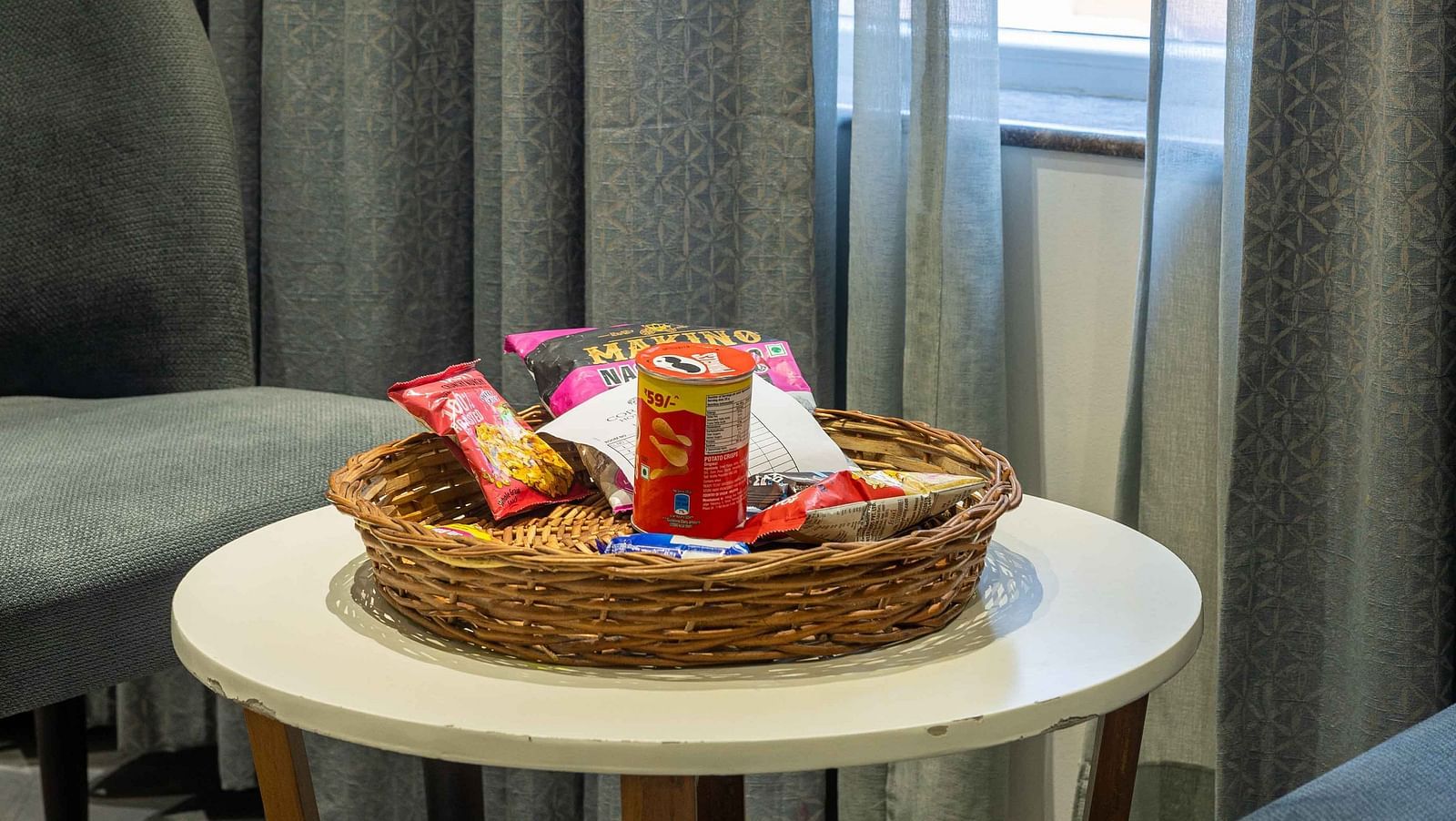Image of varieties of snacks placed on a small bamboo basket on the coffee table at Coral Reef Hotel and Spa in Port Blair