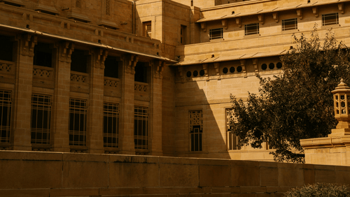 A grand heritage building with a majestic dome stands proudly, reflecting timeless architectural beauty.