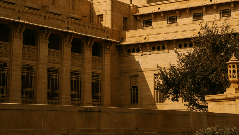 A grand heritage building with a majestic dome stands proudly, reflecting timeless architectural beauty.