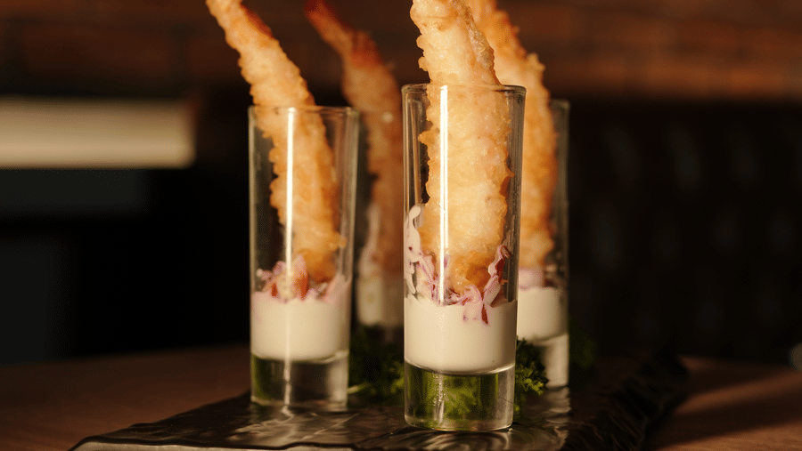Trio of signature cocktails displayed on a bar counter with artistic presentation at Trino Bar at The Citrine, Bangalore.