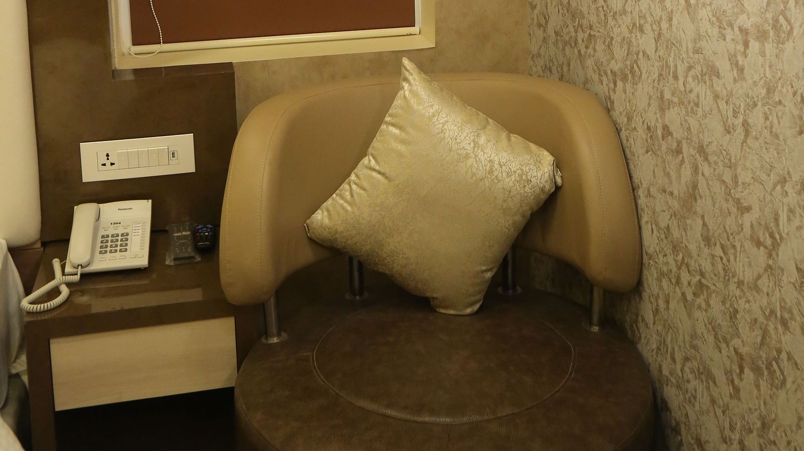 Club Suite corner with a chair, a small table, and a lamp.