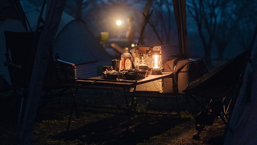 A dimly lit romantic dinner set up.