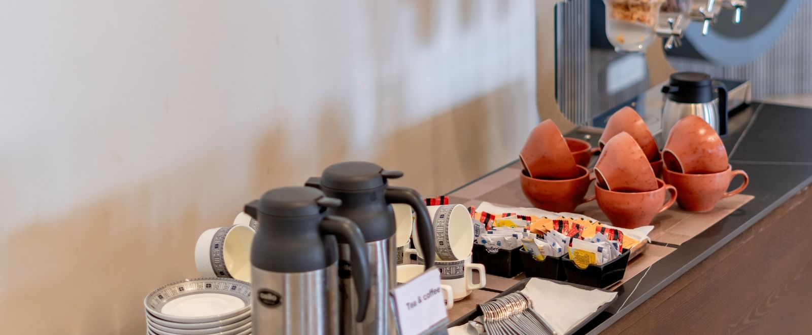 Close-up of a buffet station with juices, fruits, and pastries | Pravasa Hotel, Vijayapura