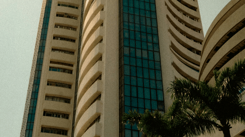 Facade view of BSE Stock Exchange in Mumbai with a bird flying next to the building.