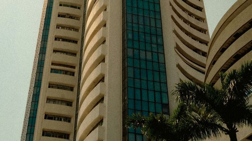 Facade view of BSE Stock Exchange in Mumbai with a bird flying next to the building.