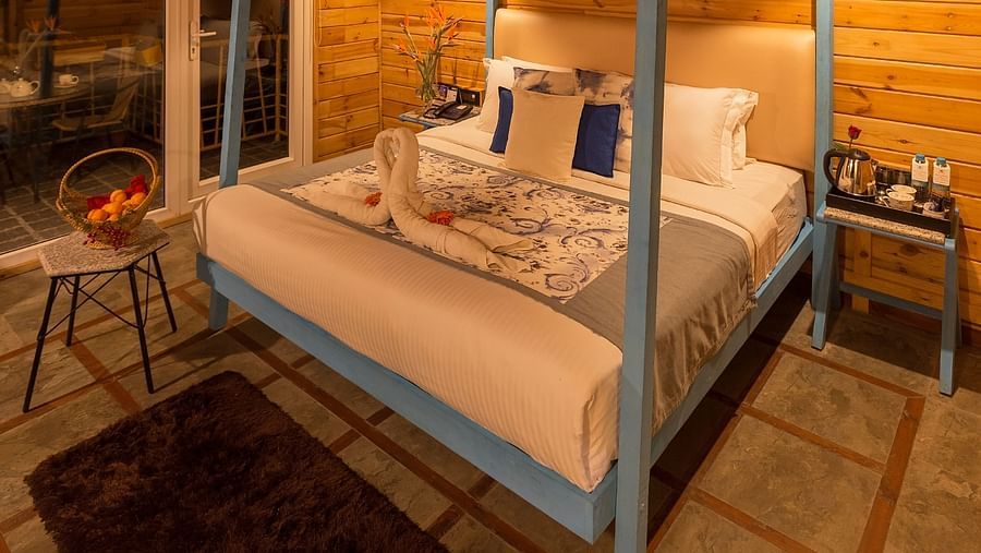 a cosy bed with wooden furnishing