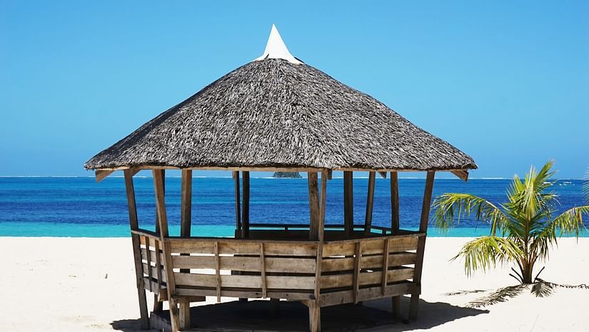 A shack on a beach with views of the beautiful sea