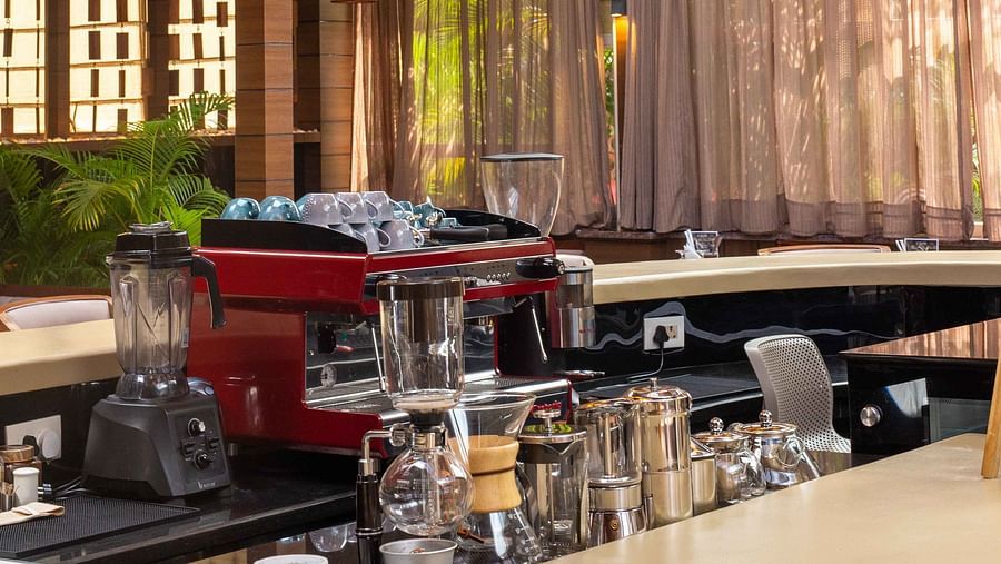 5th Bistro Cafe and Bar featuring a stylish bar area with contemporary lighting fixtures and modern furniture. The space is well-lit, creating an inviting environment for guests to relax and socialise - Coral Reef Resort & Spa, Havelock
