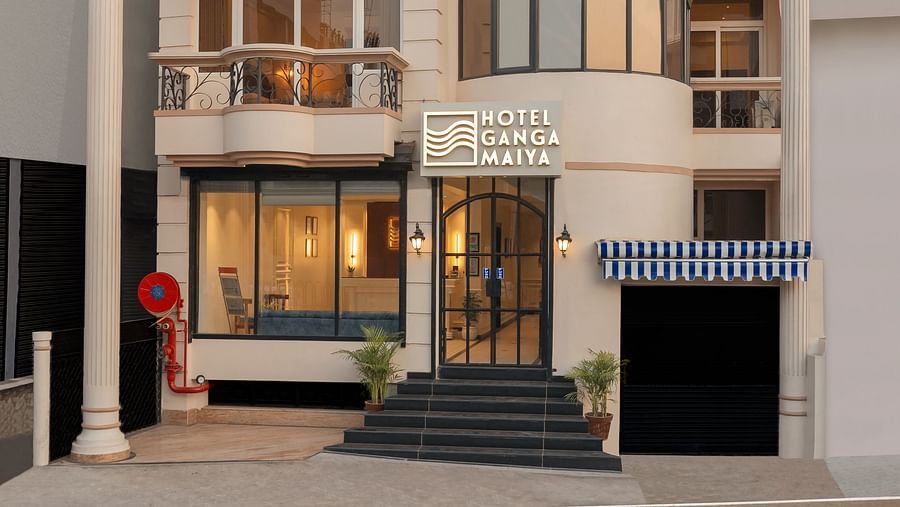 Facade view of Hotel Ganga Maiya set against a clear sky | Hotel Ganga Maiya