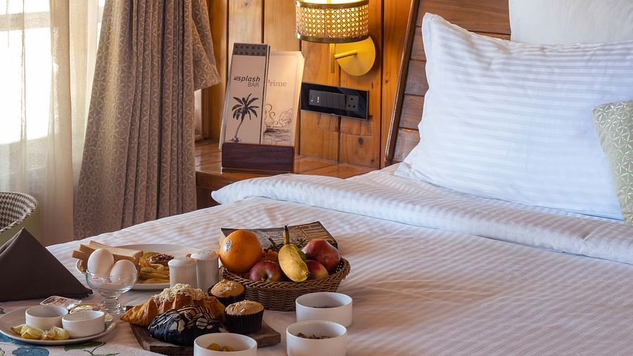 Coral Turquoise at Coral Reef Resort and Spa in Havelock featuring an angular shot of the plush bed with breakfast placed on it next to the window