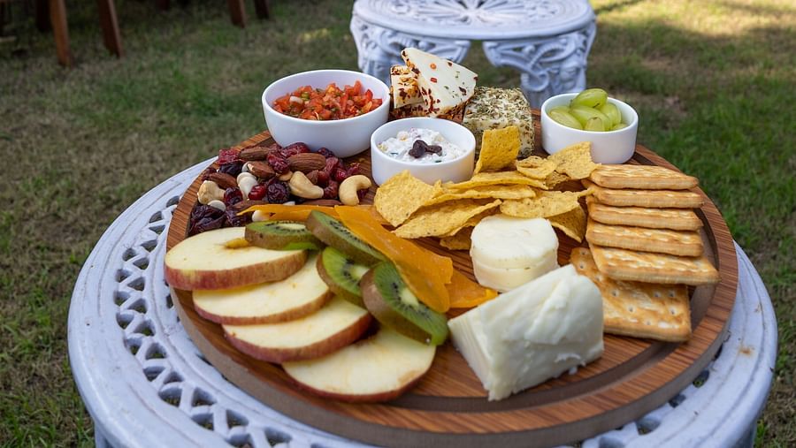 a table spread of cheese and bread - Neer Ganga Resorts