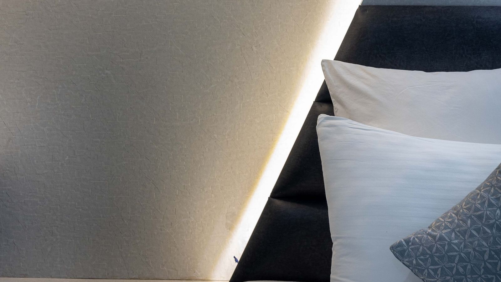 Image of Coral Premium Room at Coral Reef Hotel and Spa in Port Blair featuring a well-lit wall with lamp and lights behind the bed
