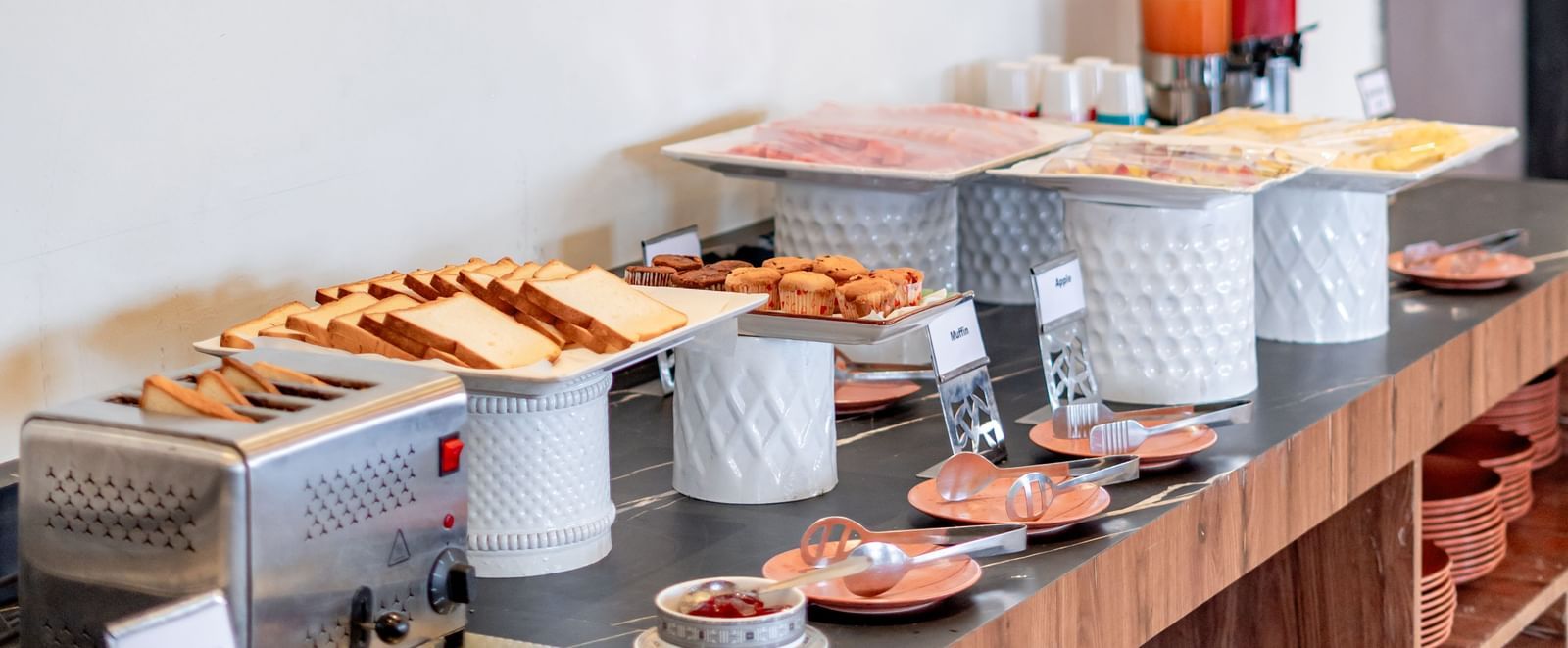 Side view of the buffet line showcasing various dishes and beverages | Pravasa Hotel, Vijayapura