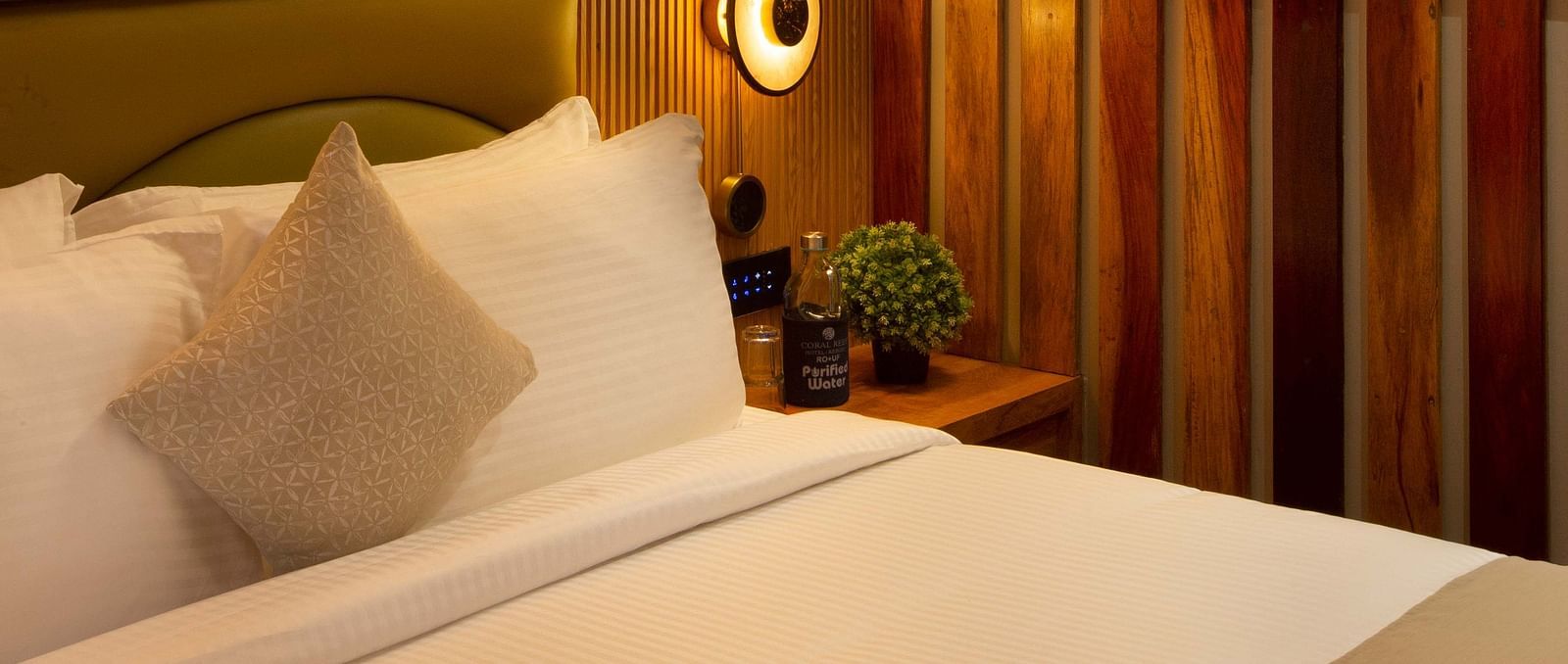 Image of Coral Sapphire at Coral Reef Resort and Spa in Havelock featuring a plush bed under warm lighting and a wall painting next to it on the wall
