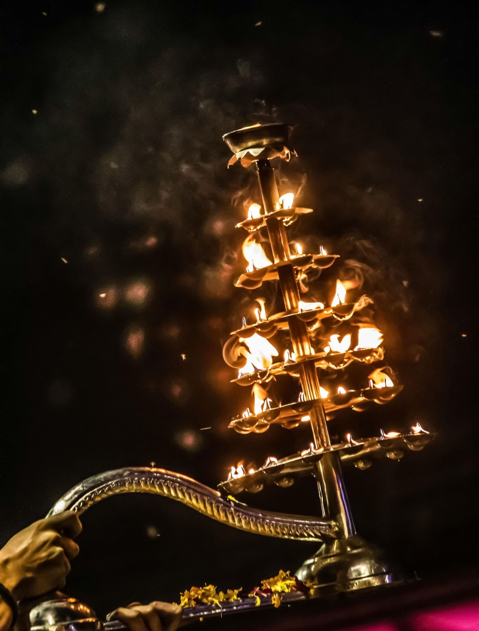 Image of a diya being used to do a arti.