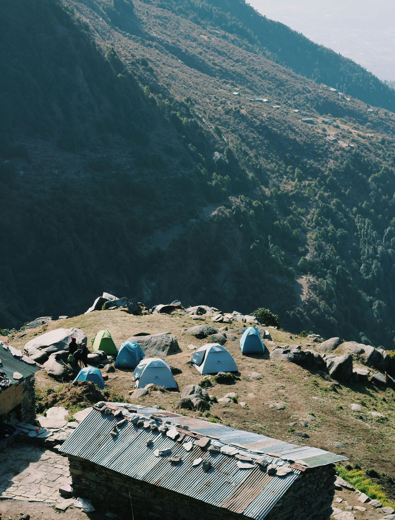 image featuring a hut with camp tents placed on the edge of the cliff in dharamshala