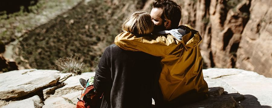 couple sitting on cliff