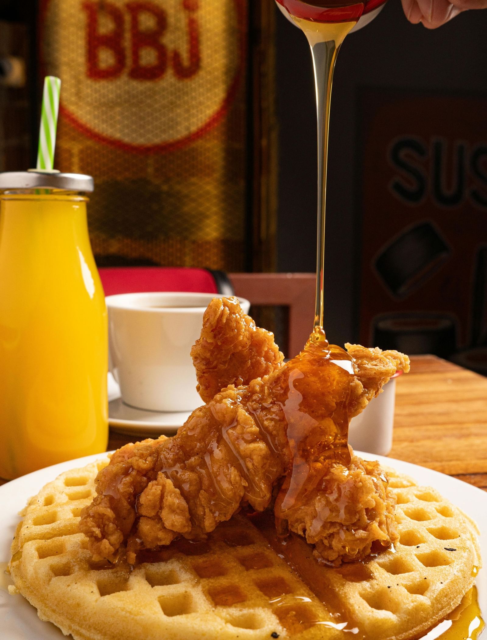 Golden fried chicken tenders on a waffle with a side of orange juice at the Tallman Hotel.