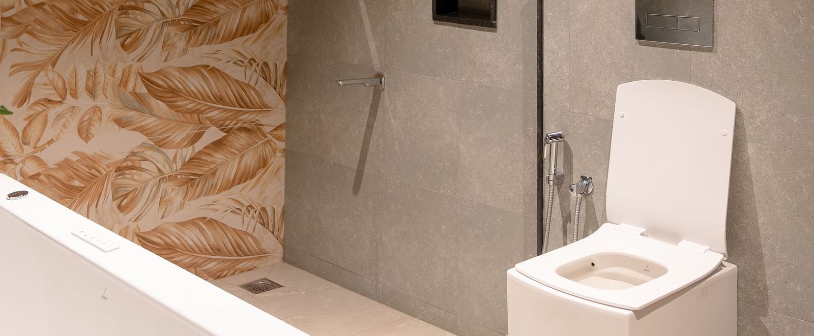 A bathroom with a unique textured wall, a toilet, and a washbasin area | Gaia Room | RD's Nature Retreat, Bangalore