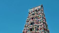 A far-out view of a temple in South India featuring Dravidian architecture of different Hindu deities on the Gopuram.
