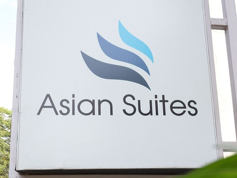 A close-up of the Asian Suites sign with a stylized logo - Asian Suites Cyber Park, Gurgaon.
