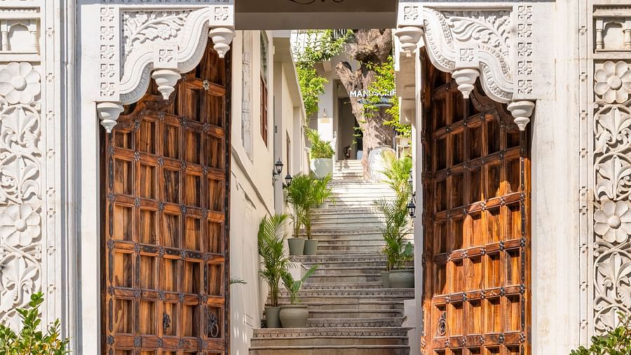 An overview of a door in view with tiled floor in front of it - Manuscript - Jhilwara Haveli, Udiapur