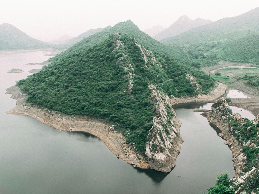 Top view of a Lake covered by hills on all sides creating a scenic landscape 